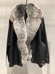 Black leather jacket with fur collar on a neutral background