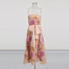 Floral dress with a bow on a mannequin against a white background