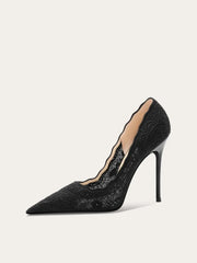 Black lace high-heeled shoe on a white background