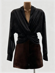 Black long-sleeve top and brown skirt on a mannequin against a white background