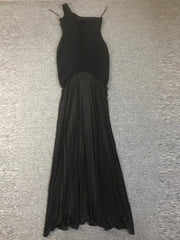 Black evening gown on a textured gray surface