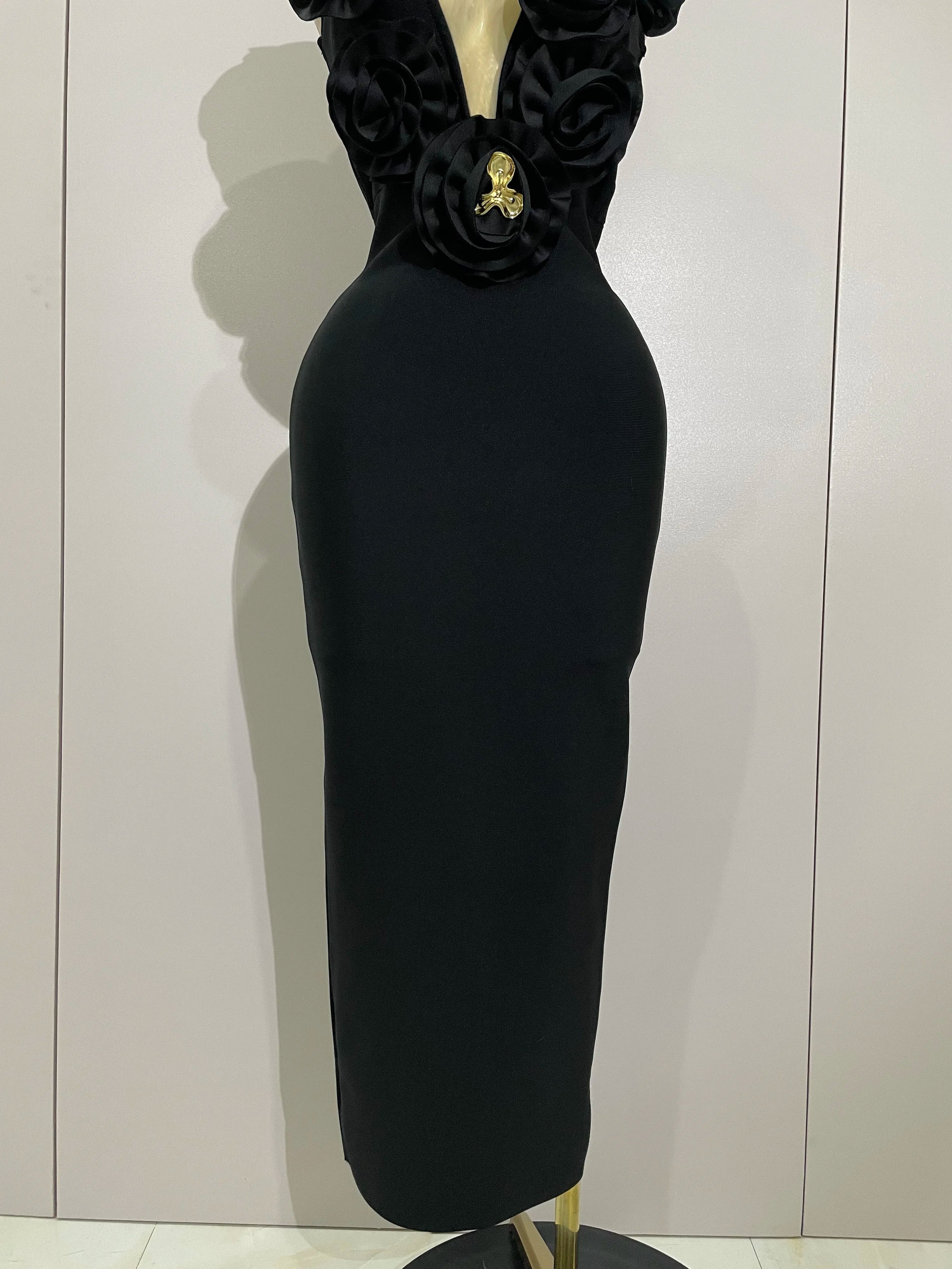 Black dress on a mannequin against a plain background