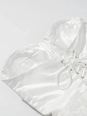 White quilted handbag with drawstring on a light gray background