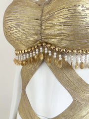 Detail of beading and sequins on gold halter dress
