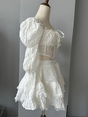 White lace outfit on a mannequin against a plain background