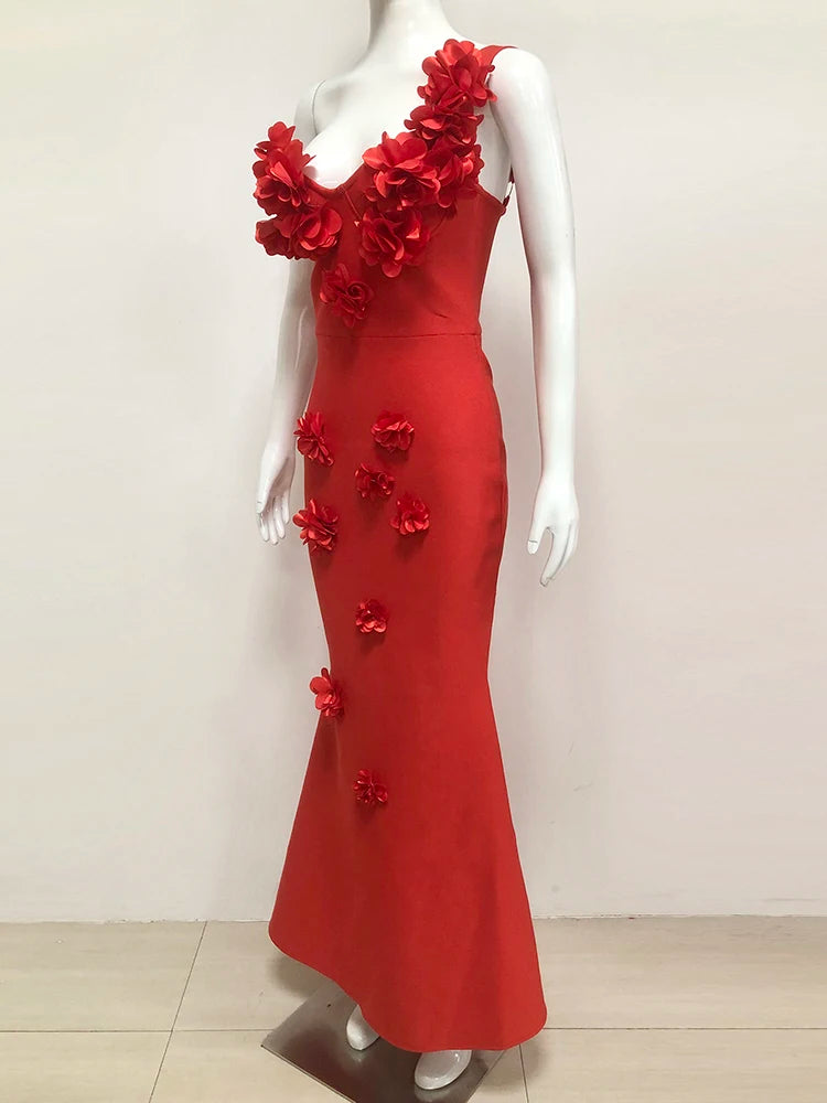 Red evening gown with floral embellishments on a mannequin against a white background