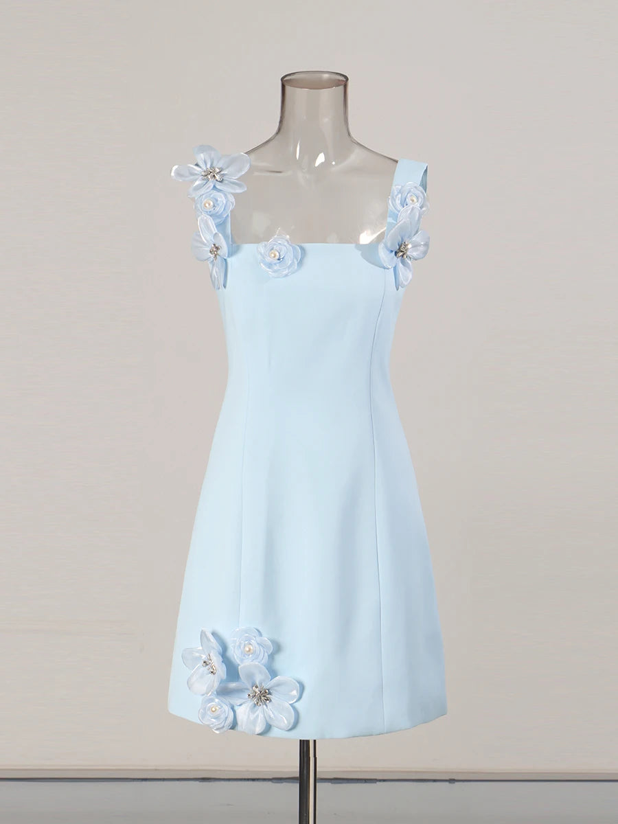 Light blue dress with floral straps on a mannequin against a beige background