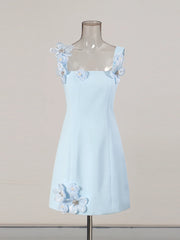 Light blue dress with floral straps on a mannequin against a beige background