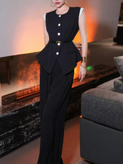 Woman wearing a black outfit with white buttons in a living room setting.