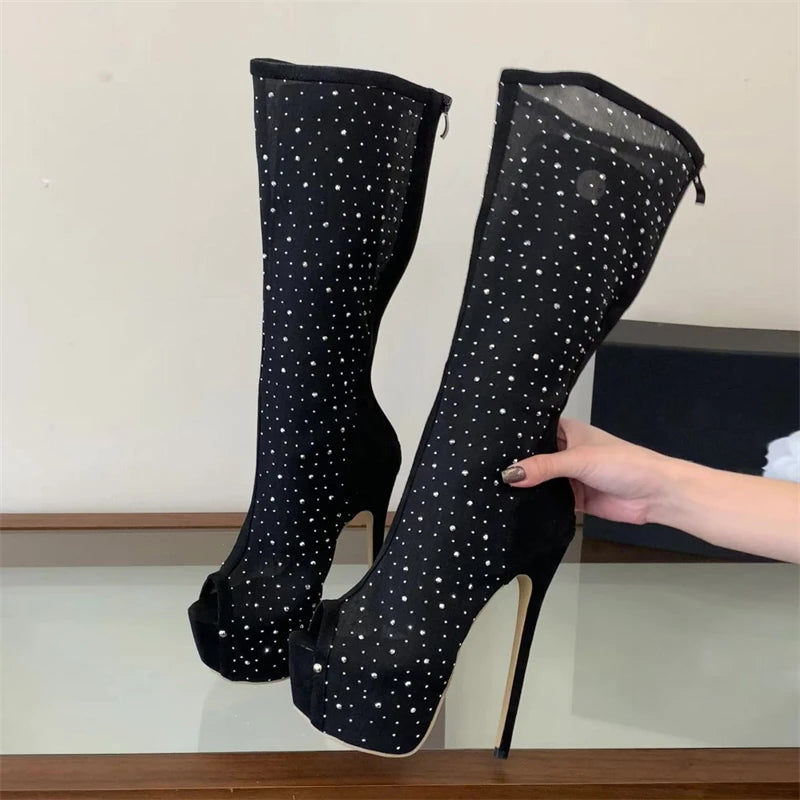 Black mesh peep toe knee-high platform boots with crystal embellishments shown with hand