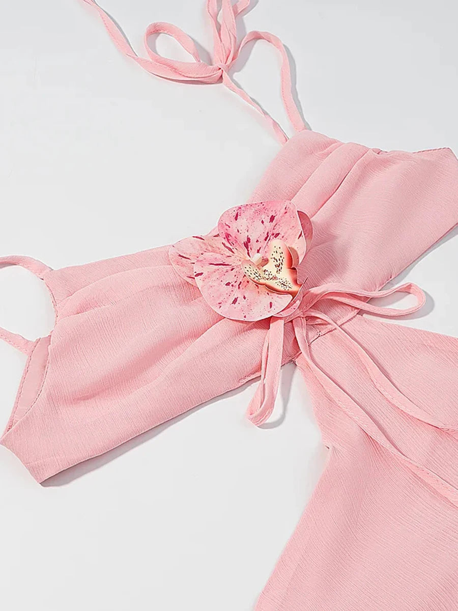 Pink bikini top with floral design on a light gray background