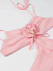 Pink bikini top with floral design on a light gray background