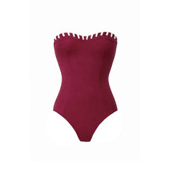 Close-up of a maroon strapless swimsuit with white contrast trim.