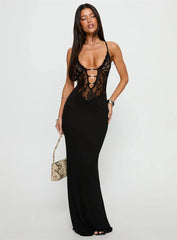 Woman wearing a black lace-up dress against a white background