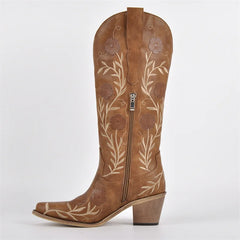 Brown leather boot with floral embroidery on a white background