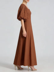 Brown dress worn by a model on a light gray background