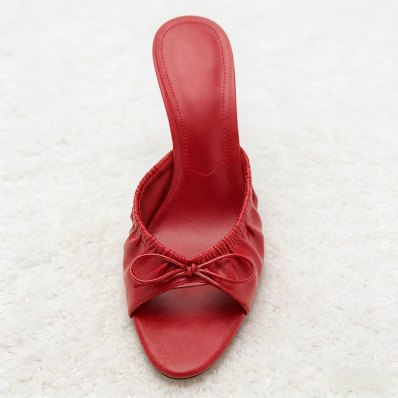 Front view of a red bow detail stiletto heel slide