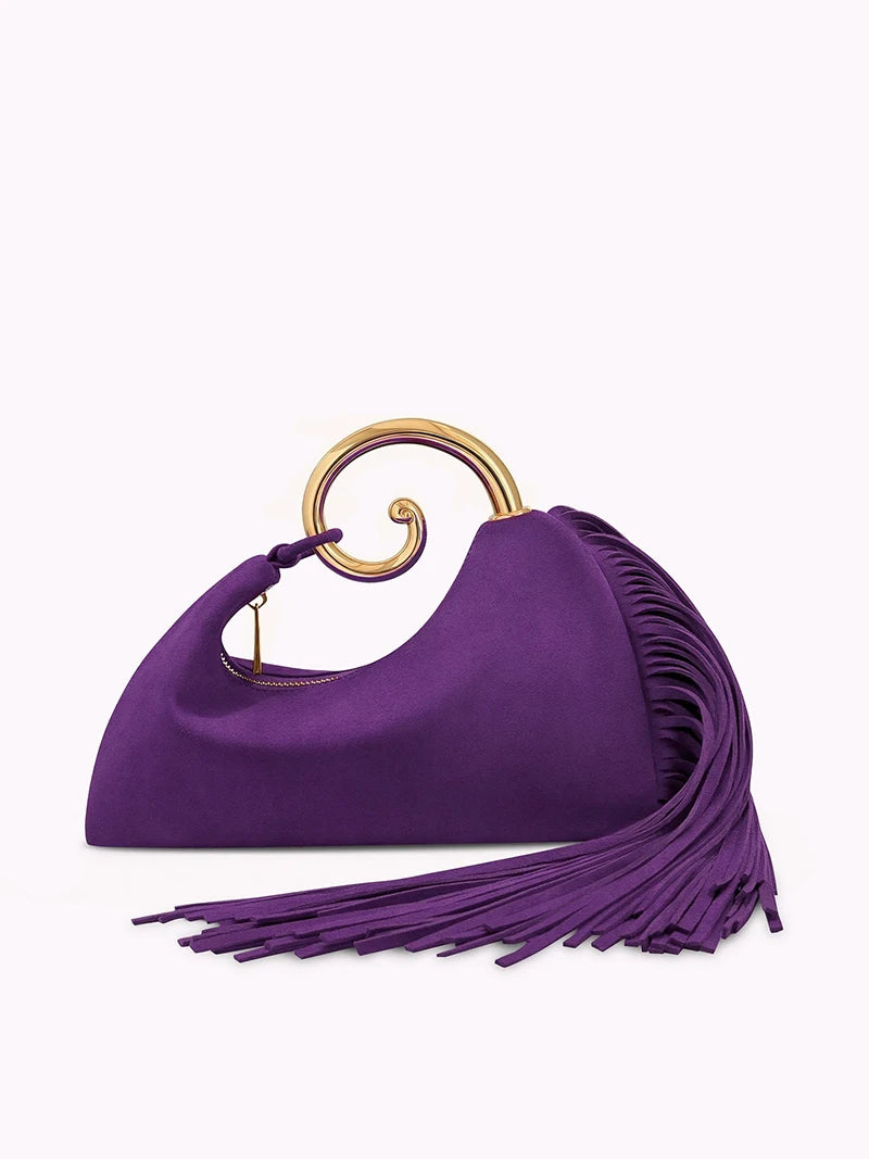 Purple handbag with gold ring handle on a white background