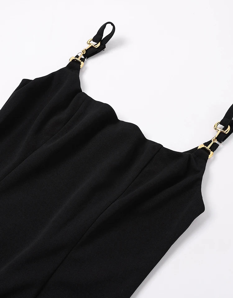 Black dress with gold straps on a white background