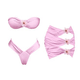 Pink floral bikini top and skirt set laid flat.