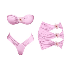 Pink floral bikini top and skirt set laid flat.
