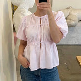 Striped puff sleeve button-front peplum top worn by a model