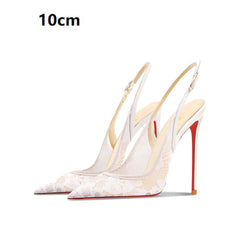 White high-heeled shoes with red soles on a white background