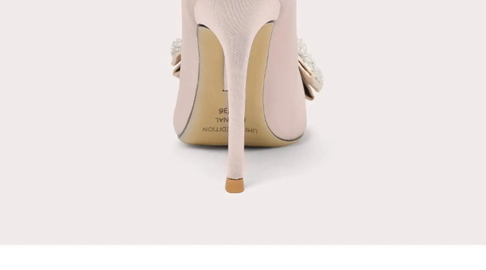 Close-up of a beige high-heeled shoe on a light gray background