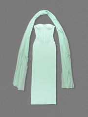 Mint green strapless dress with sheer sleeves on a gray background