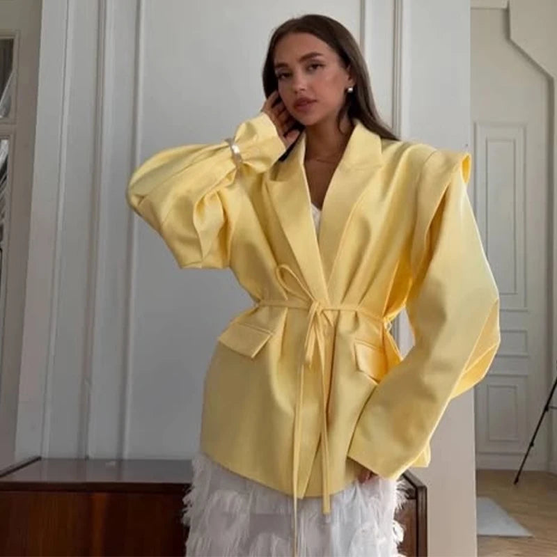 Woman wearing a yellow jacket in an indoor setting