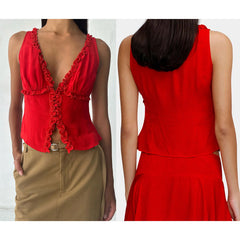 Red sleeveless top with ruffled back and beige skirt on a white background