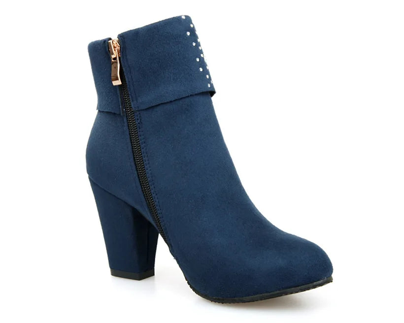Blue ankle boot with a block heel on a white background
