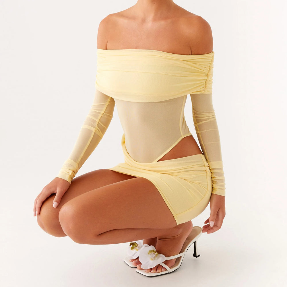 Woman wearing a yellow off-shoulder outfit on a white background