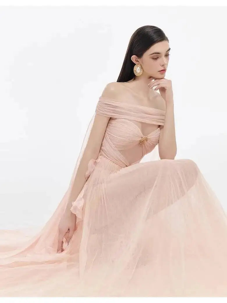 Close-up of a model in an off-the-shoulder mesh evening gown