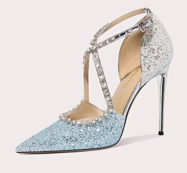 Sparkly high-heeled shoe with decorative straps on a white background