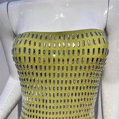 Mannequin wearing a yellow strapless top with silver embellishments on a white background