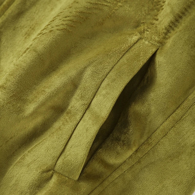 Close-up of a textured green fabric with folds
