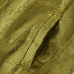 Close-up of a textured green fabric with folds