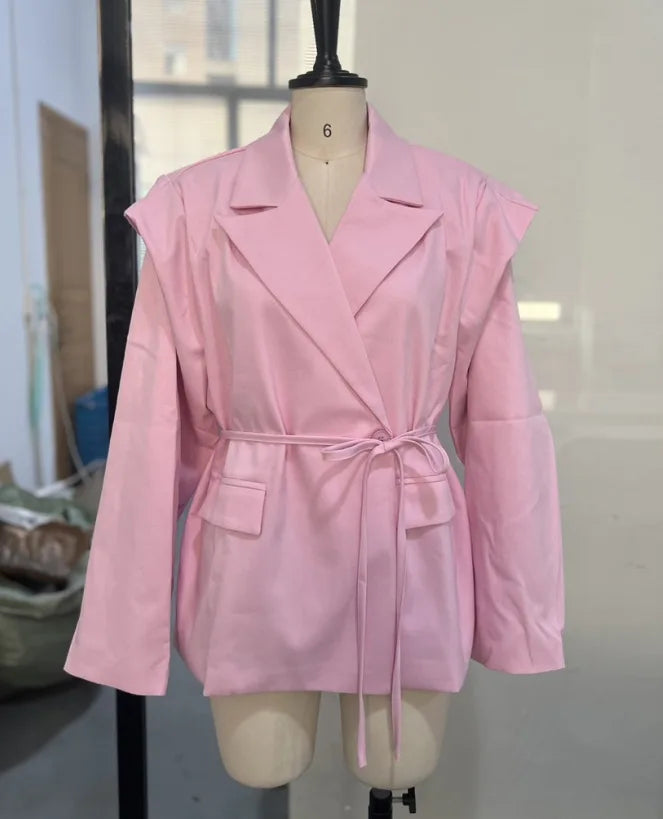 Pink trench coat on a mannequin against a neutral background