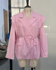 Pink trench coat on a mannequin against a neutral background