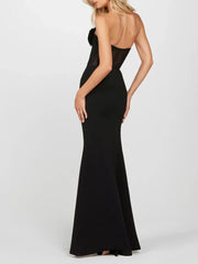 Black evening gown with open back on a white background