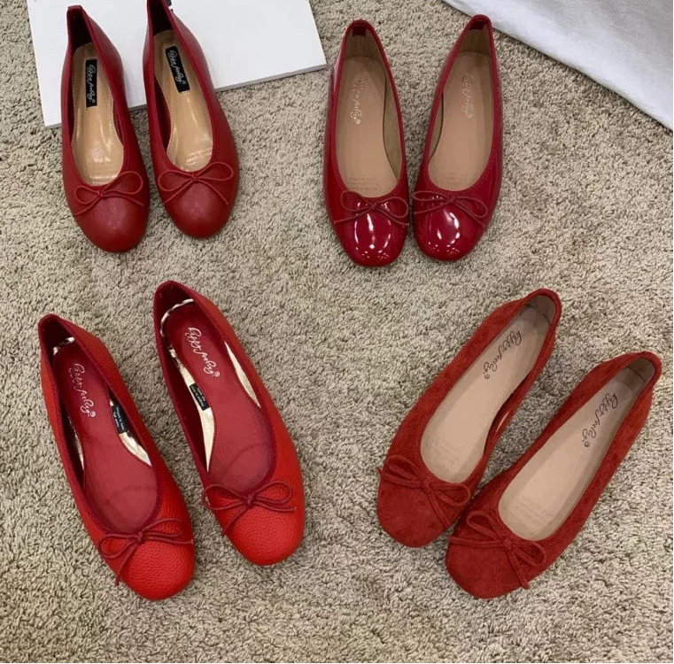 Red ballet flats with a bow detail and round toe.