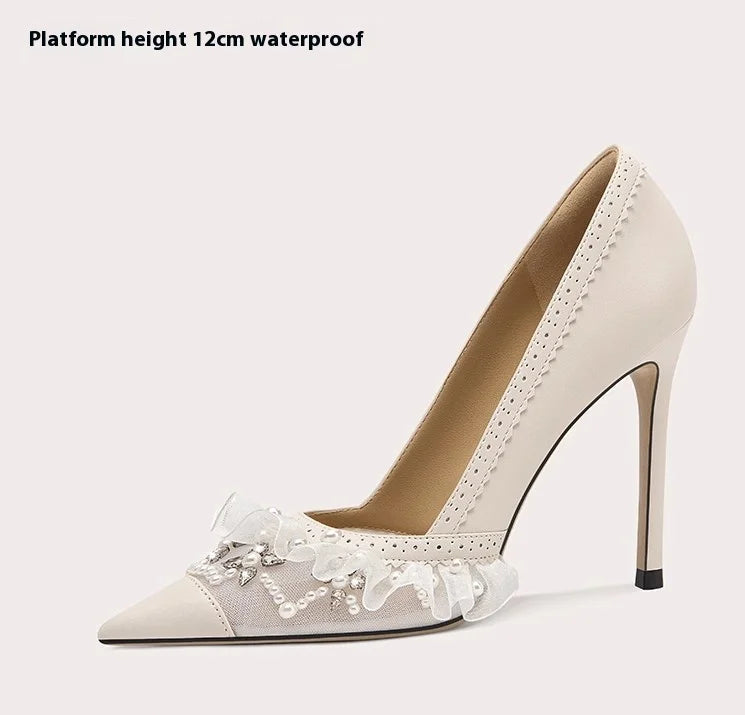 Beige high-heeled shoe with lace details on a white background