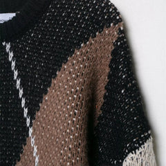 Close-up of a black, brown, and white patterned fabric on a white background