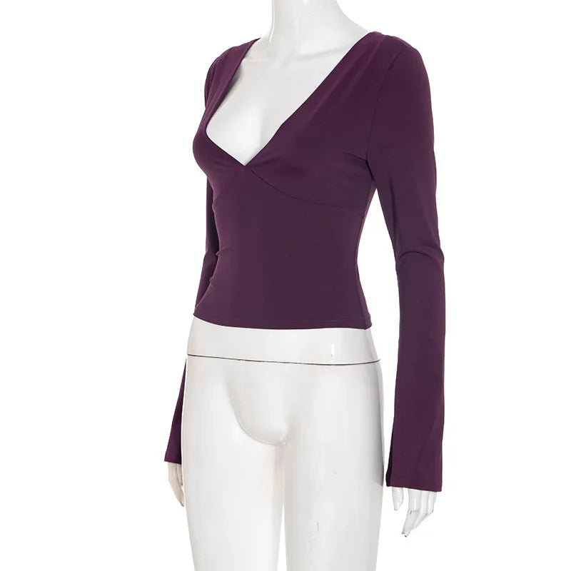 Purple long-sleeve top on a mannequin against a white background