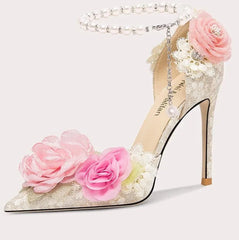 High-heeled shoe with floral decorations on a white background