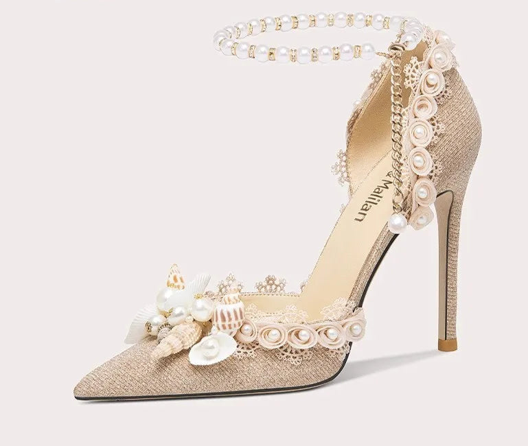 High-heeled shoe with floral and pearl details on a light gray background
