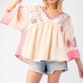 Embroidered V-neck flare sleeve top in cream and pink.