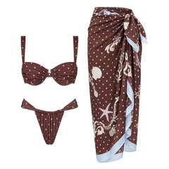 Two-piece polka dot bikini with ruched details and contrast trim, featuring a sweetheart-style bustier top and tie-side bottoms, paired with a coordinating polka dot skirt.