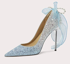 Sparkly high-heeled shoe with a decorative bow on a white background